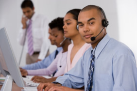 man with headset in front of computer