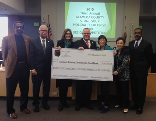 Board of Supervisors presenting donation check to Alameda County Food Bank Executive Director, Suzan Bateson