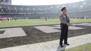 image of police man on baseball field